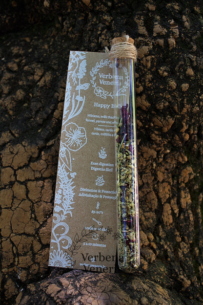 chemist glass tube closed with a cork top tighten with some  ropes. It contains the herbal blend called happy belly. A kraft label tag is attached to it, with all the information regarding the herbs.