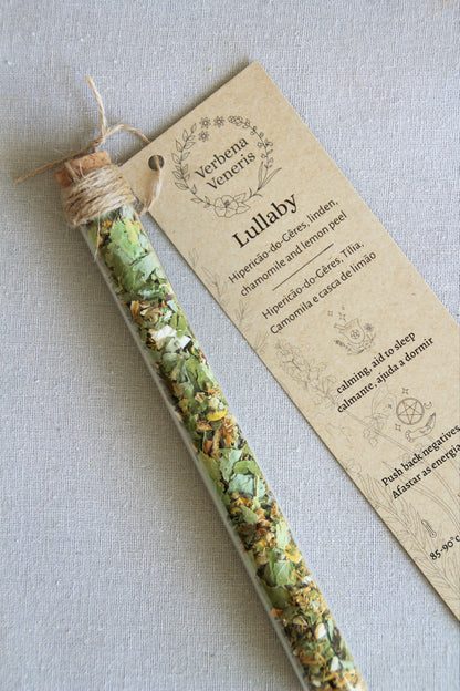 chemist glass tube closed with a cork top tighten with some  ropes. It contains the herbal blend called Lullaby. A kraft label tag is attached to it, with all the information regarding the herbs.