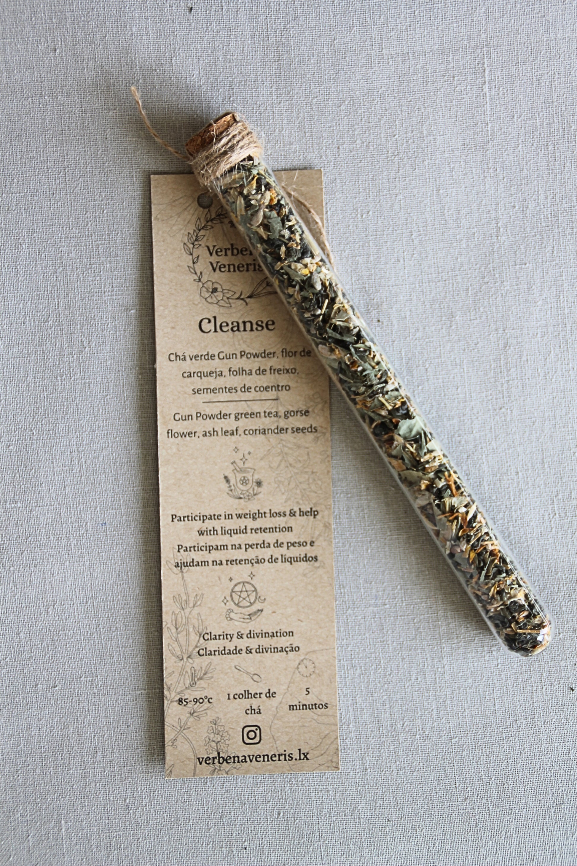 chemist glass tube closed with a cork top tighten with some  ropes. It contains the herbal blend called Cleanse. A kraft label tag is attached to it, with all the information regarding the herbs.