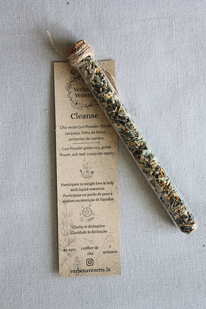 chemist glass tube closed with a cork top tighten with some  ropes. It contains the herbal blend called Cleanse. A kraft label tag is attached to it, with all the information regarding the herbs.
